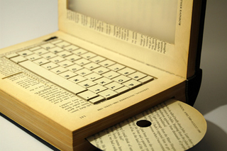 Illustration for article titled The Laptop Book Makes a Deep Statement, But No One Cares Because It's a PC in a Book!